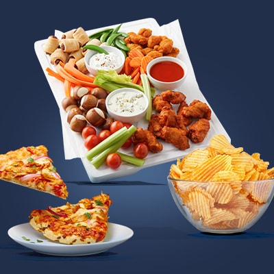 Game day food spread with chicken wings, pizza and chips