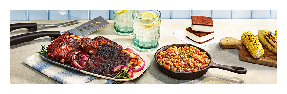Plated ribs, baked, beans, and beverage