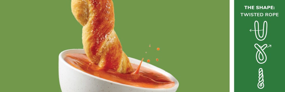 pretzel dunked in tomato soup