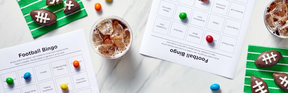 tablescapeo of football bingo cards, football truffles and galsses of soda