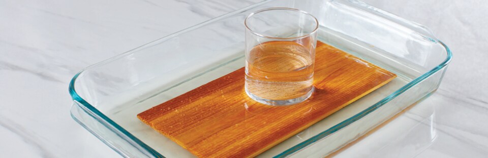 soaking wood plank in glass baking dish of water