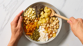 hands mixing trail mix