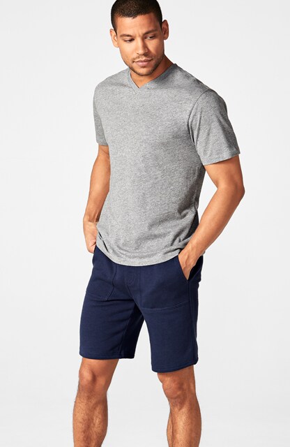 man in gray t-shirt and blue shorts