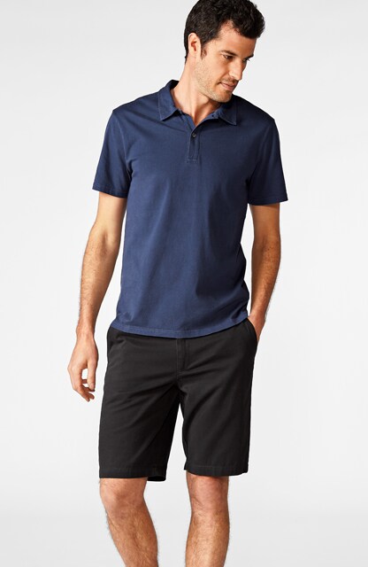 man in blue polo and black shorts