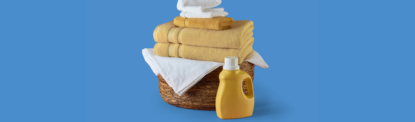 Basket of clean towels and detergent bottle