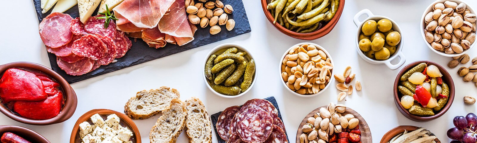 A variety of meats and cheeses, nuts and pickled vegetables to build a charcuterie board A variety of meats and cheeses, nuts and pickled vegetables to build a charcuterie board