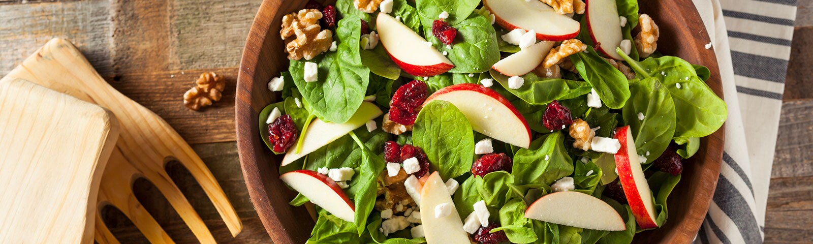 Apple, walnut and spinach salad in a serving bowl Apple, walnut and spinach salad in a serving bowl