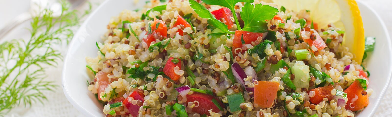 Bowl of cooked quinoa, tomatoes and onion Bowl of cooked quinoa, tomatoes and onion
