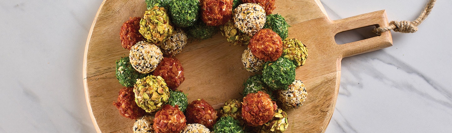 mini cheeseballs on a round wood platter