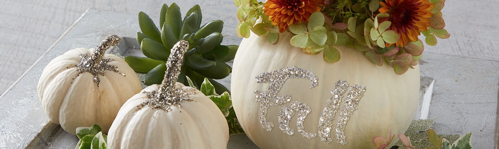 Silver glitter on white pumpkins Silver glitter on white pumpkins