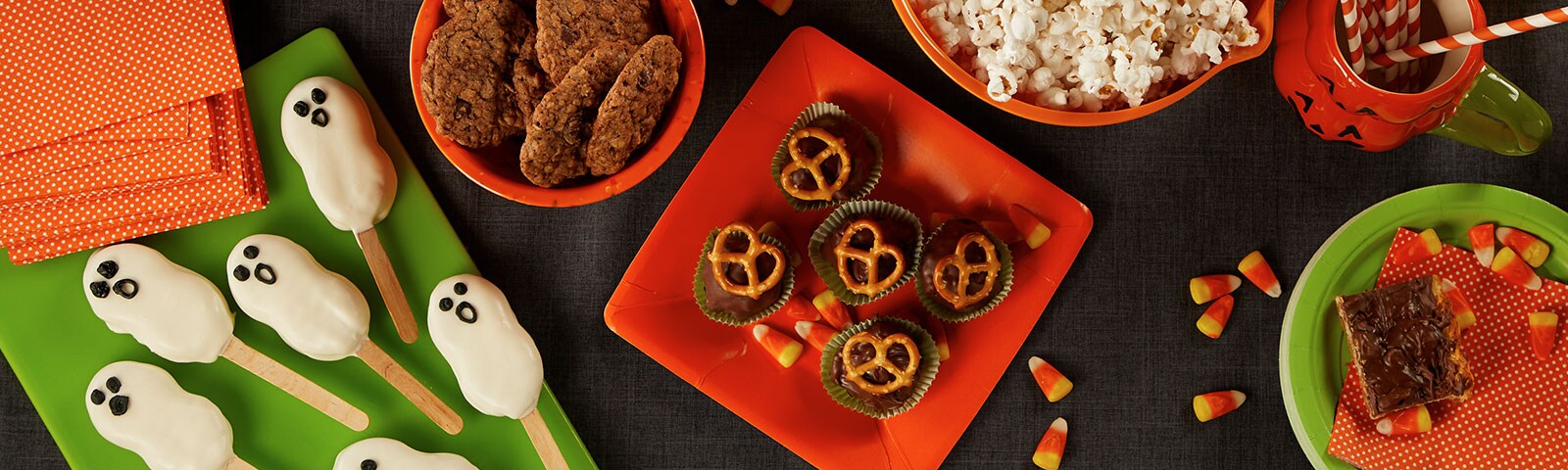 A table jam-packed with halloween treats and from cookies, to cake pops decorated as ghosts, to latex gloves filled with popcorn A table jam-packed with halloween treats and from cookies, to cake pops decorated as ghosts, to latex gloves filled with popcorn