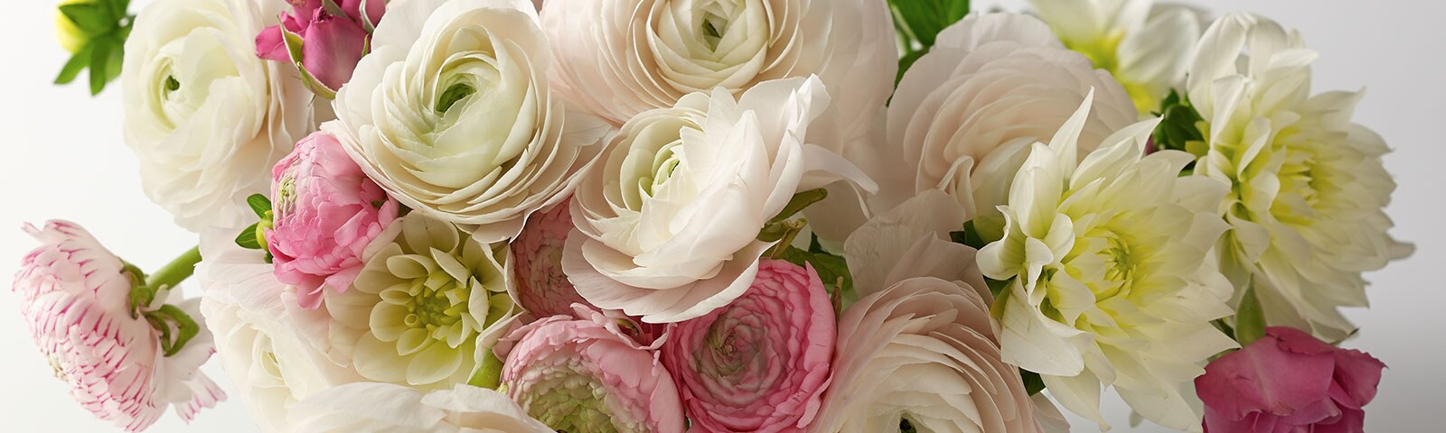  A bouquet of beautiful summer flowers with pastel colors sitting in a vase 