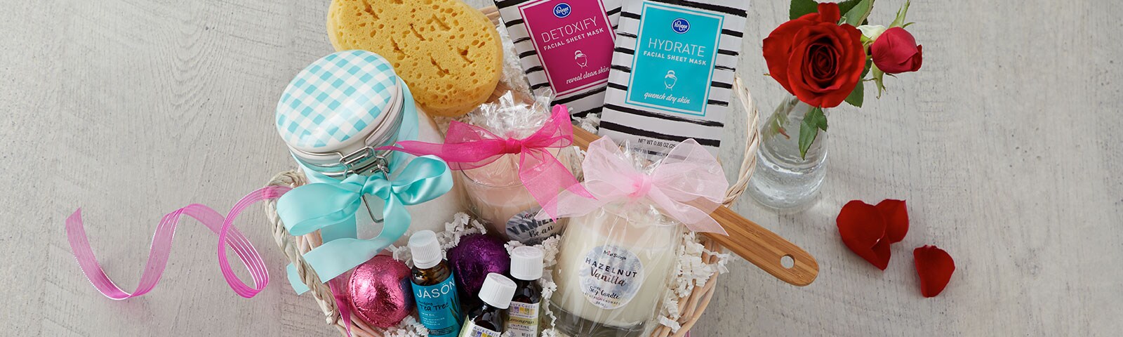 Gift basket filled with valentine's date checklist items such as candles, bath bombs and face masks