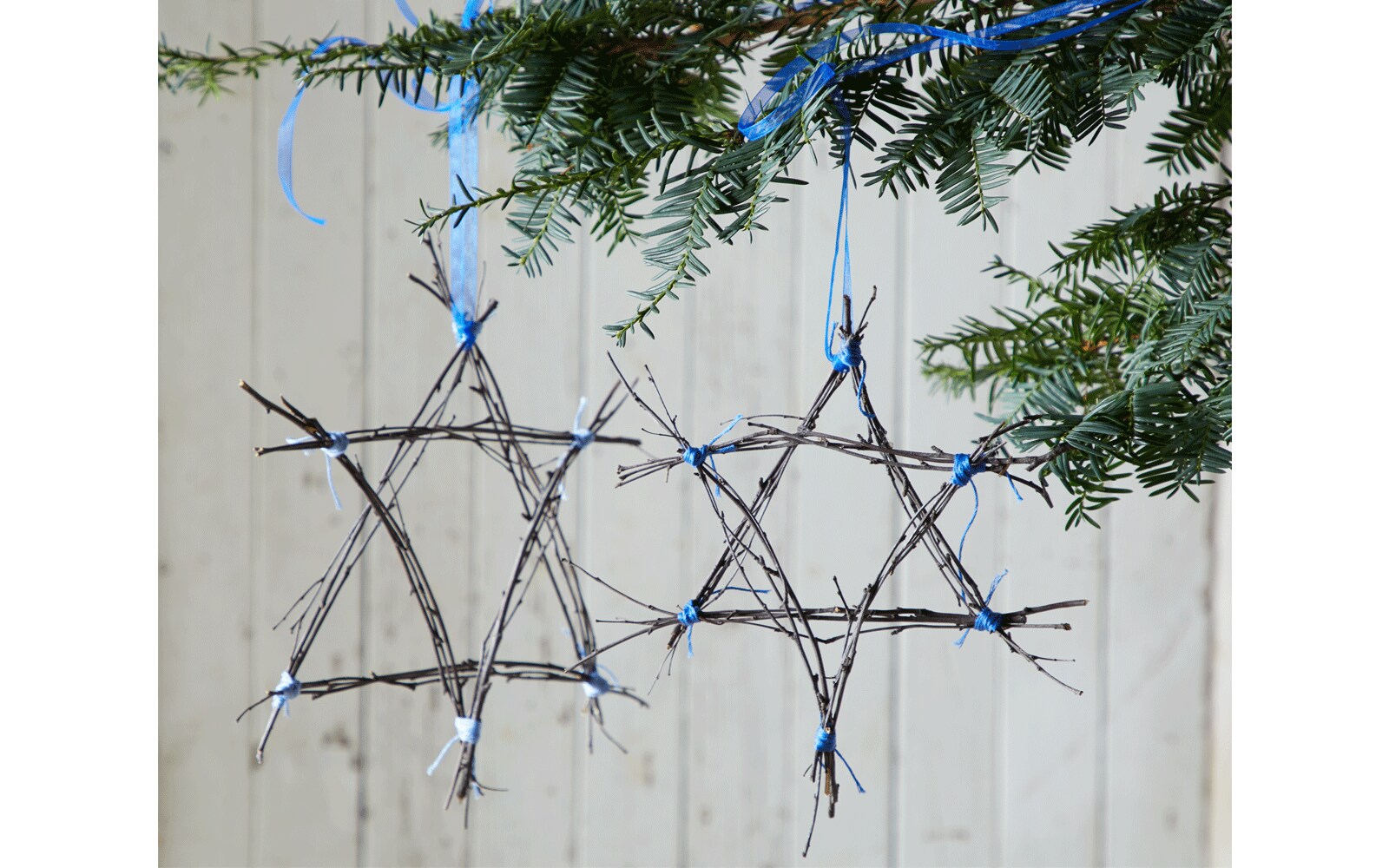 Holiday star made out of twigs tied with ribbon Holiday star made out of twigs tied with ribbon