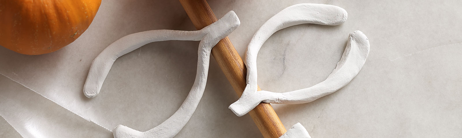Clay wishbones on wooden spoon Clay wishbones on wooden spoon