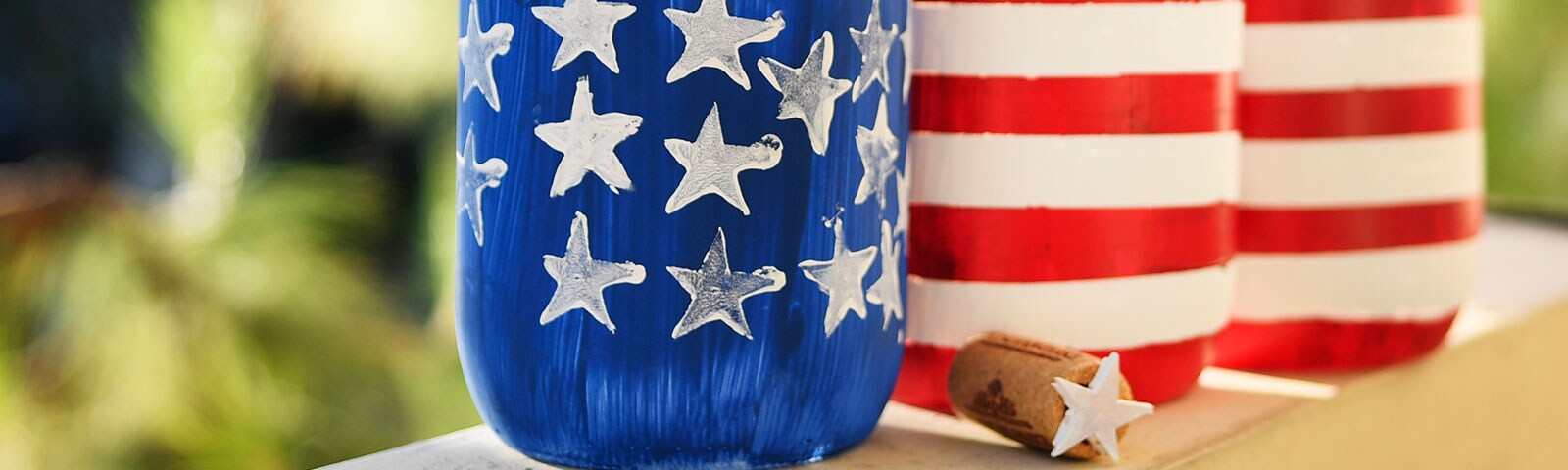 Mason jars painted with the stars and stripes of the American Flag
