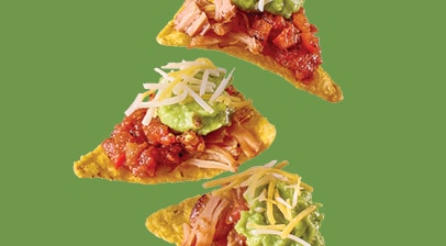 Nachos with carnitas, salsa, guacamole and shredded cheese
