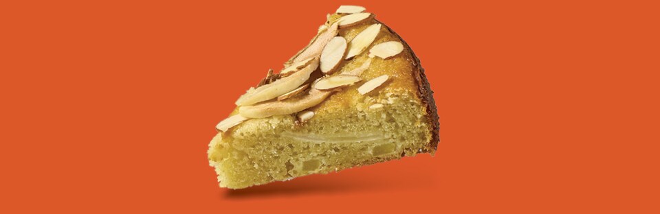 A single slice of Gluten-Free Pear Al-mond Cake floating on an orange background