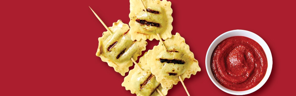 Grilled ravioli on skewers with marinara sauce